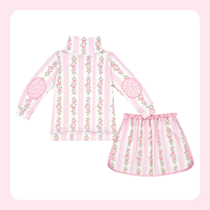 A two-piece girls' outfit set featuring a long-sleeve mock-neck top and a matching skirt, both in a pink and white striped pattern with vertical floral vines and pink lace-like elbow patches.