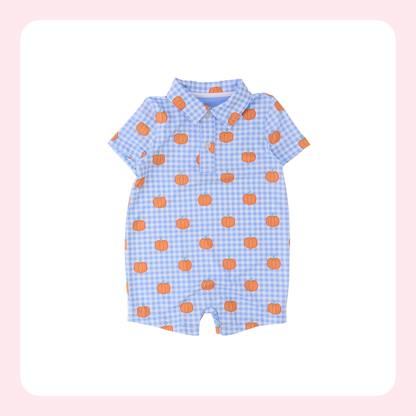A baby short-sleeve romper with a light blue and white gingham check pattern and orange pumpkin prints, displayed on a white background with a soft pink border.