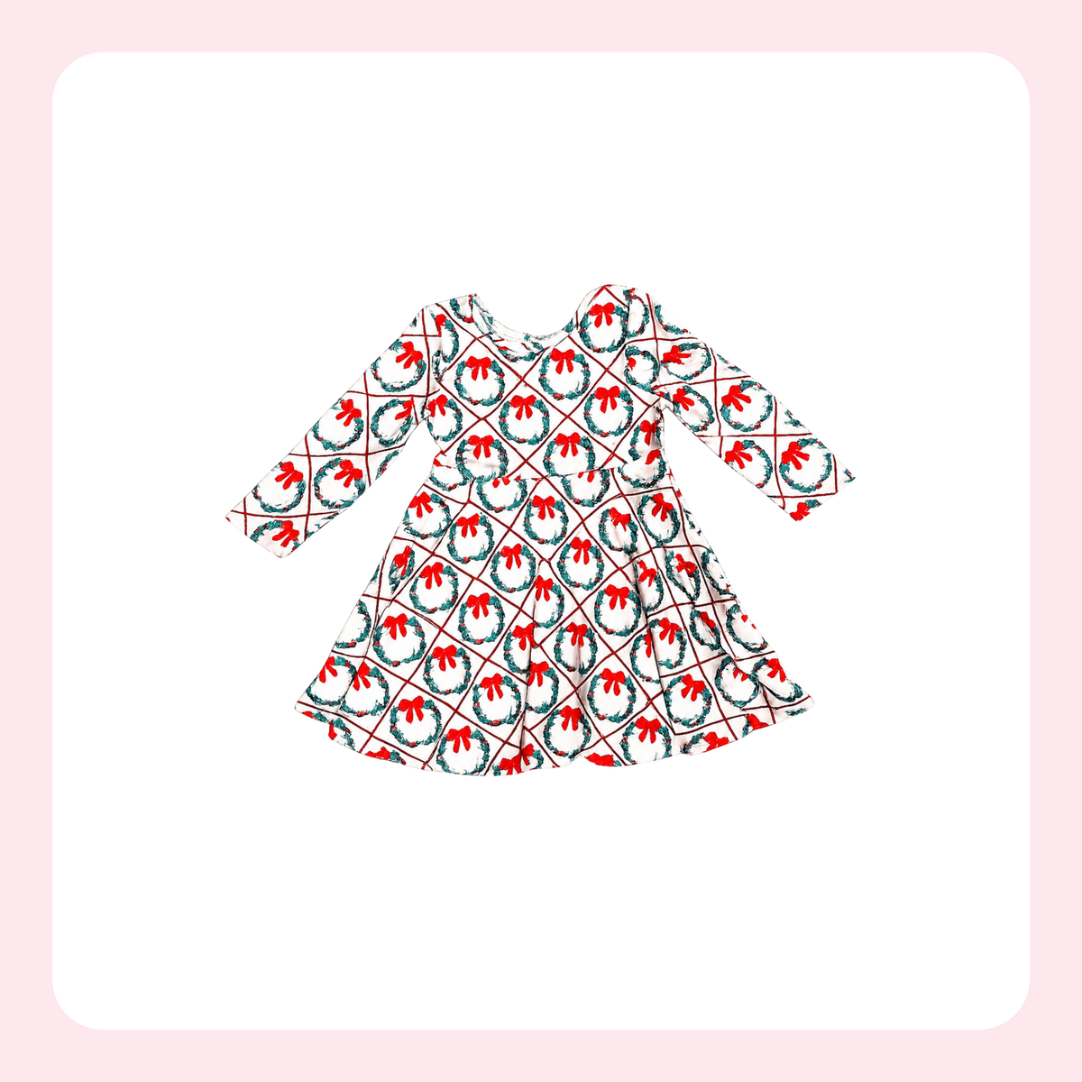 A long-sleeve dress with a festive holiday pattern featuring red bows, green wreaths, and thin red and black diagonal lines on a white background, centered on a light pink rounded square backdrop.