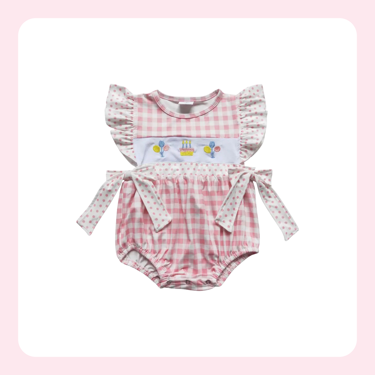 A baby girl's two-piece outfit featuring a pink and white gingham romper with ruffle sleeves and a matching long-sleeve top with a birthday balloon and cake graphic, displayed on a white background with a soft pink border.