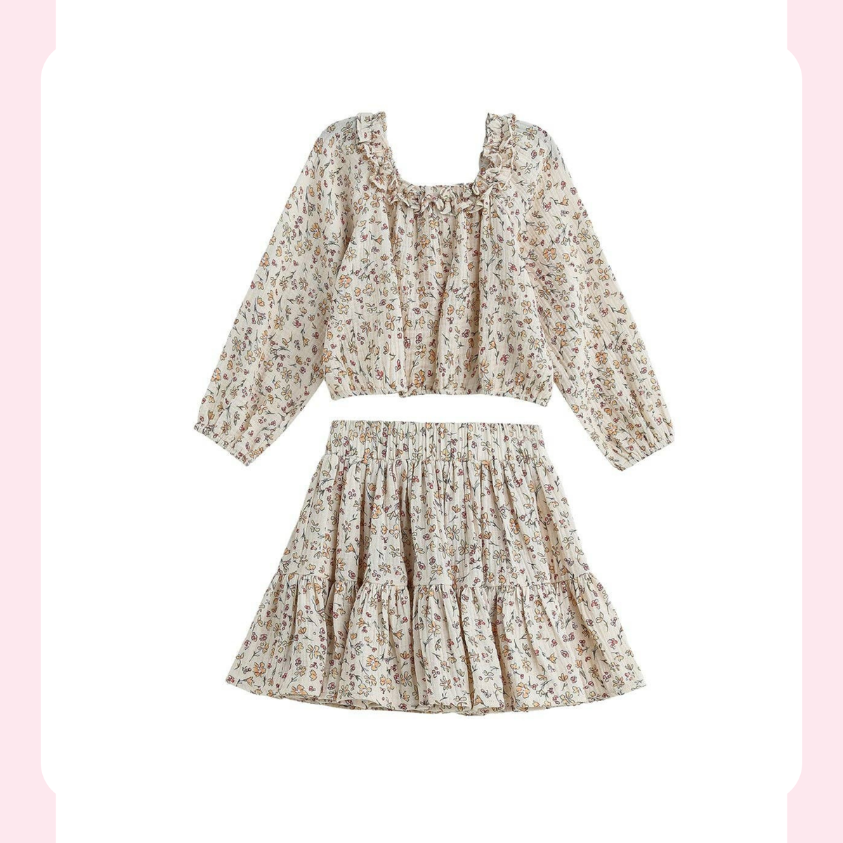 A two-piece girls' outfit set featuring a long-sleeve cropped blouse and a matching tiered mini skirt, both in a beige base fabric with a small multicolor floral print, shown on a white background with a decorative pink border.