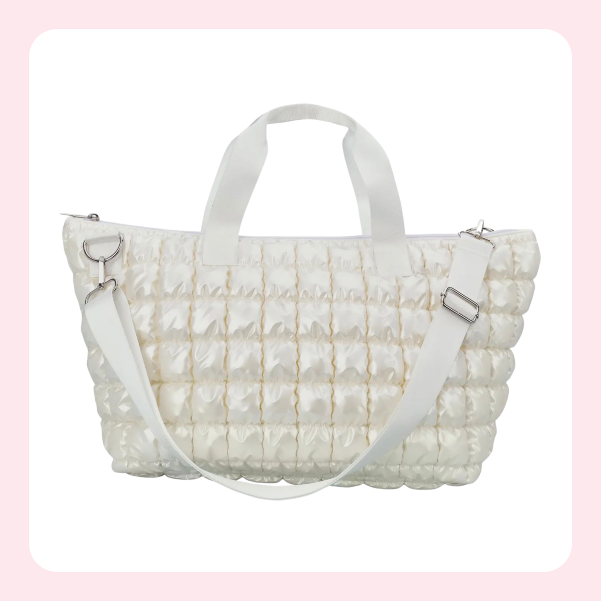 A white quilted puffer tote bag with dual top handles and a matching shoulder strap, shown against a white background with a soft pink border.