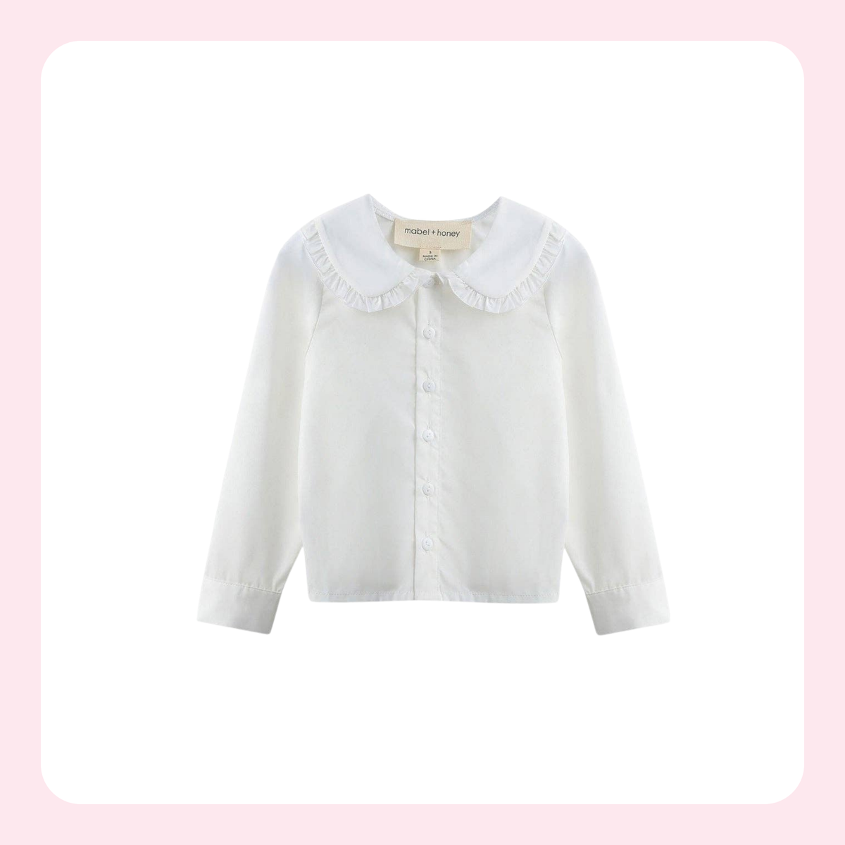 A white long-sleeve button-up blouse for toddlers, featuring a ruffled Peter Pan collar and a small button placket, shown against a white background with a light pink border.