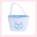 A small fabric bucket bag with a light blue and white gingham pattern, featuring a light blue embroidered jack-o'-lantern face on the front and a matching light blue handle, set against a white background with a soft pink border.