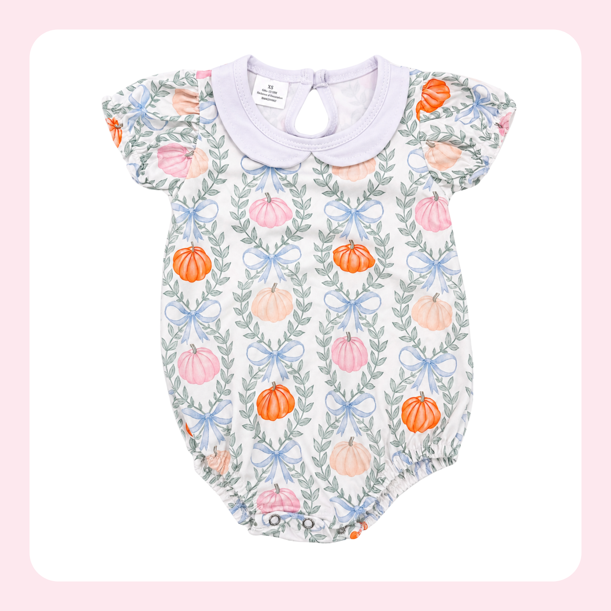 A baby romper with a white base, featuring a repeating pattern of orange and pink pumpkins, green leaves, and light blue bows, finished with a light purple collar.