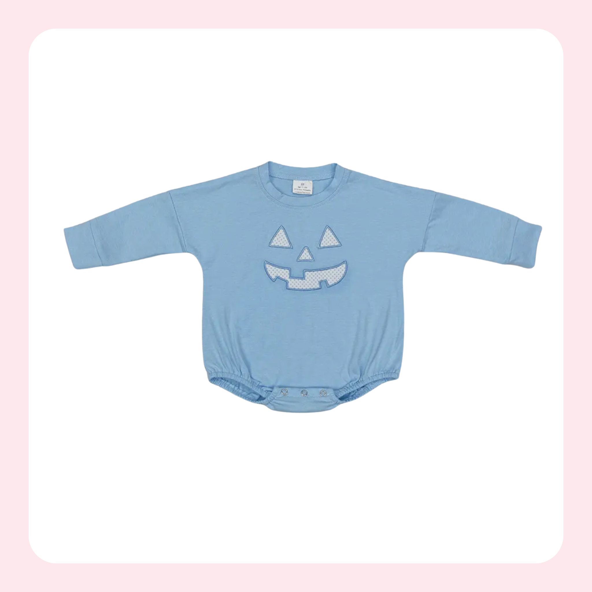 A baby long-sleeve bodysuit in light blue, featuring a sequined jack-o'-lantern face on the chest, displayed flat against a white background with a soft pink border.