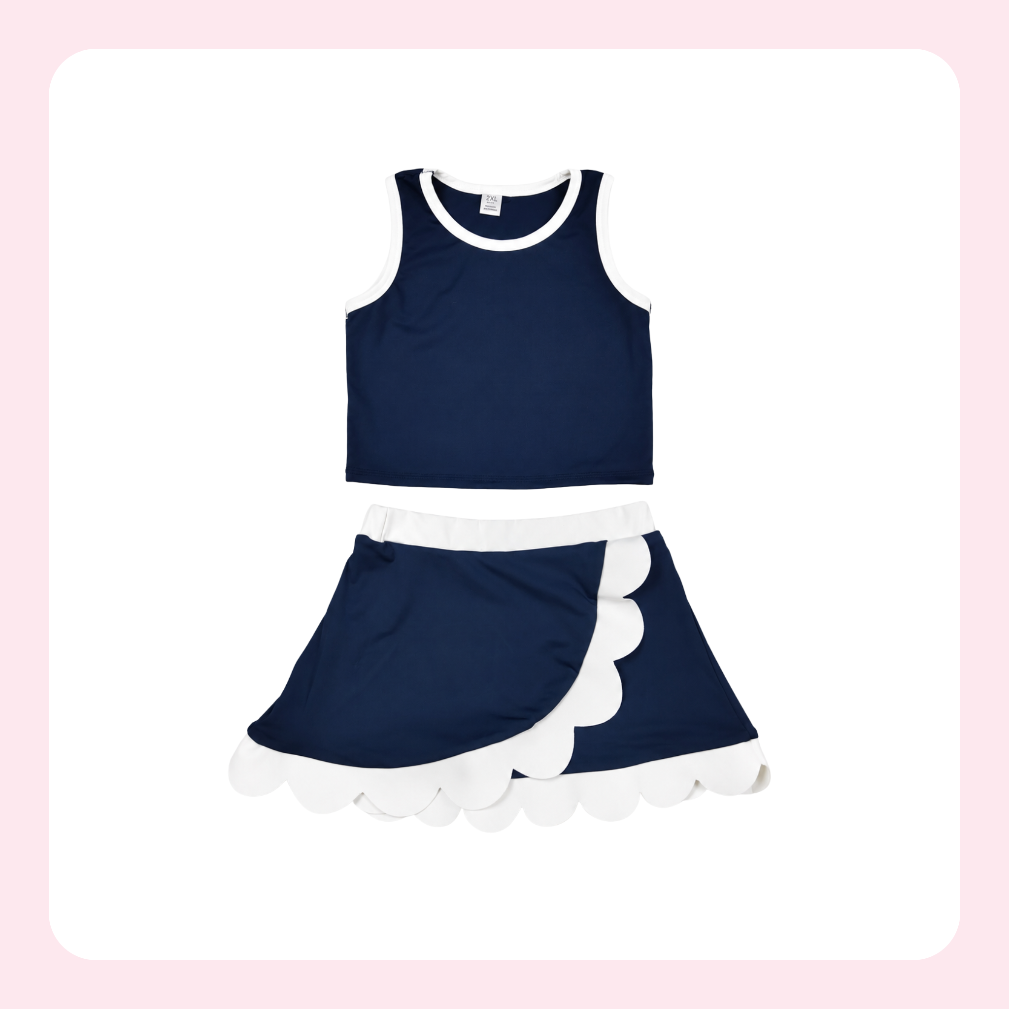 A two-piece girls' outfit set consisting of a navy blue sleeveless crop top with white trim and a matching navy blue skirt with a white ruffle and scalloped edge, displayed on a white background with a light pink border.