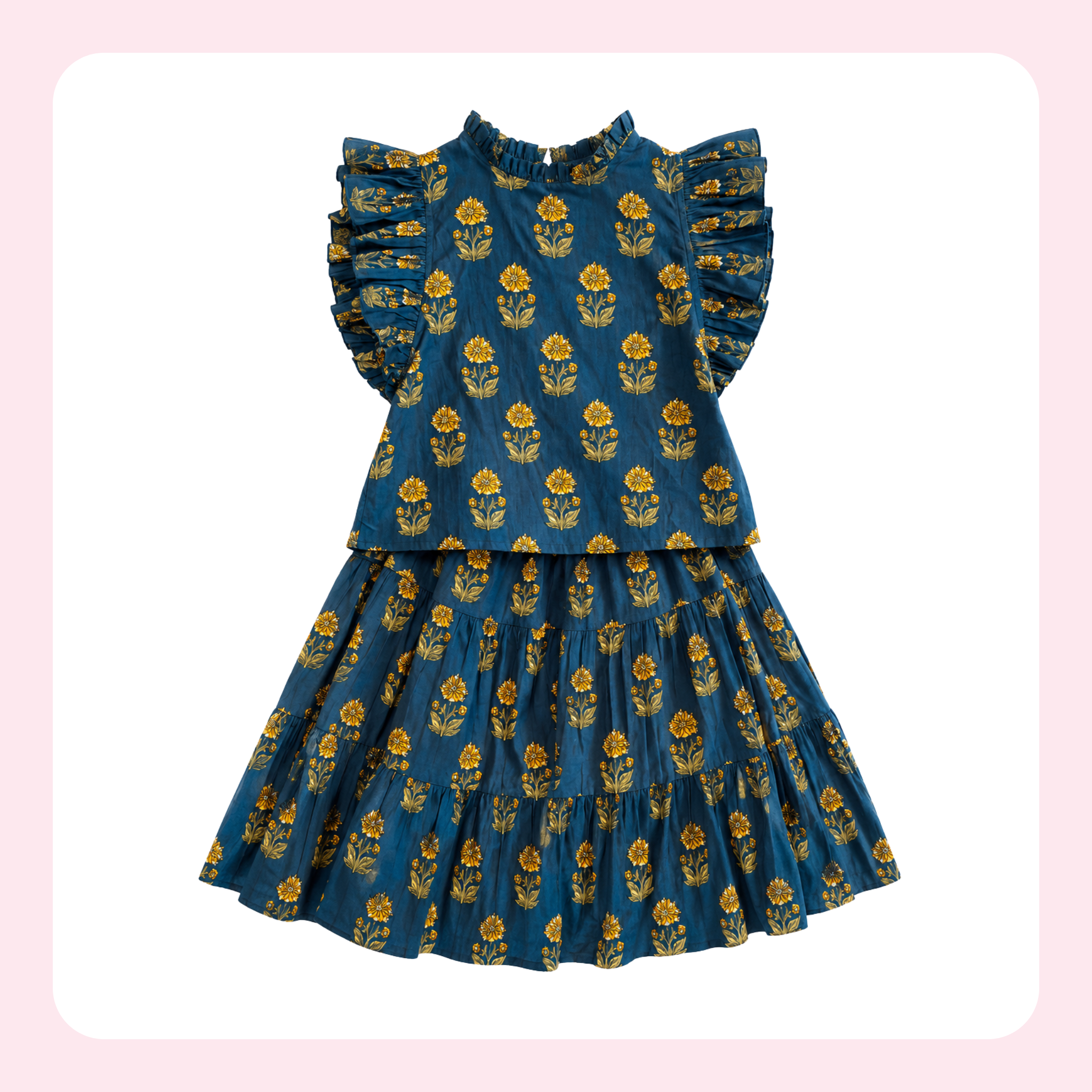 A toddler girl's tiered dress in dark teal blue with a yellow and green floral block print, featuring ruffled cap sleeves and a high neckline, shown against a white background with a light pink border.