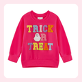 A bright pink long-sleeve sweatshirt with 'TRICK OR TREAT' and a ghost applique on the front, displayed on a white background with a soft pink border.